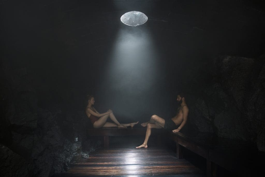 couple_relaxing_in_dark_sauna